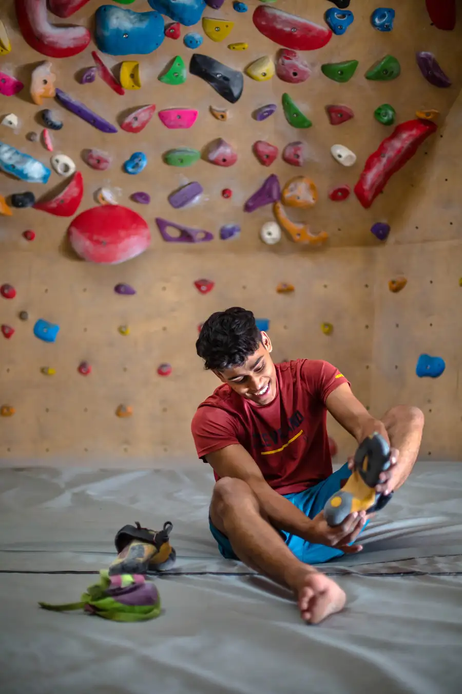 A climber on a bouldering wall at BoulderBox