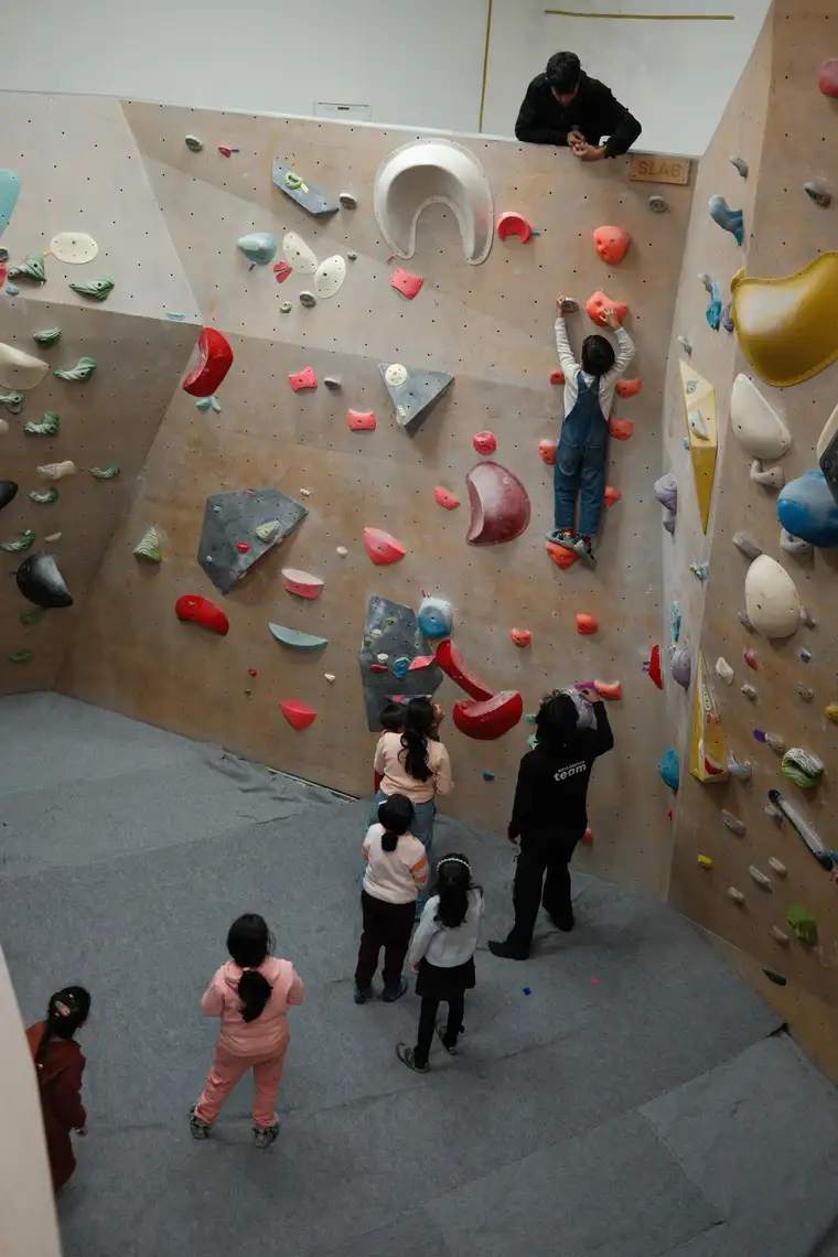 A child climbs the wall during a birthday party