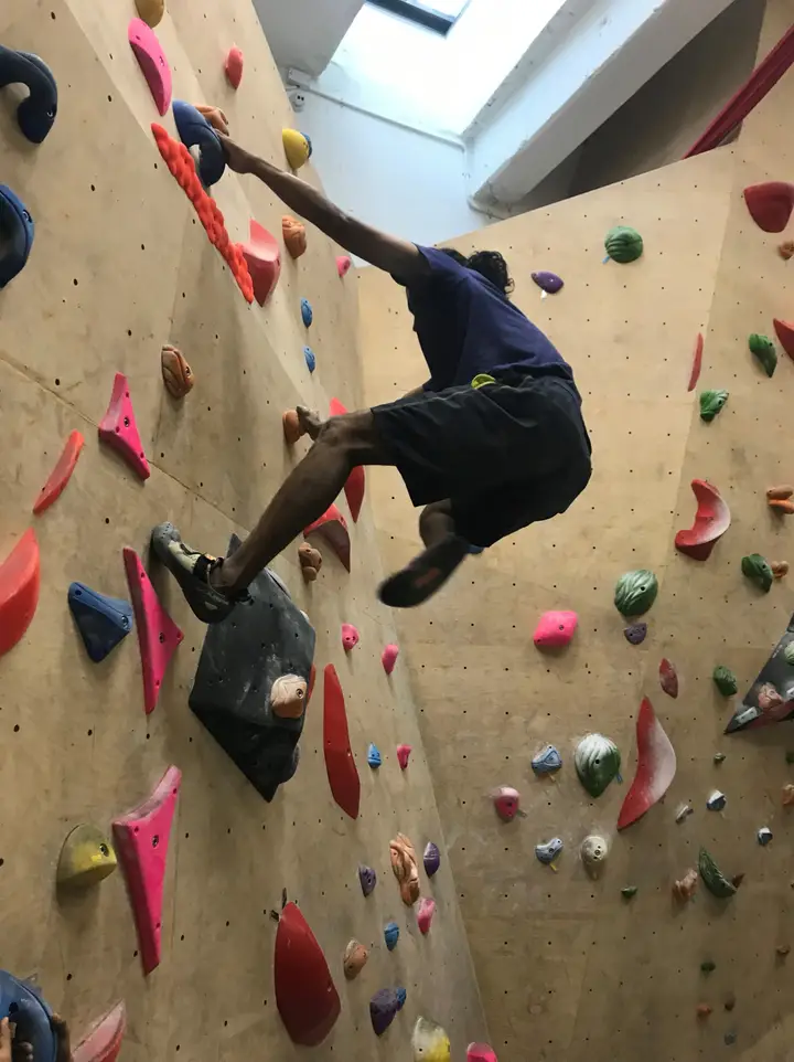 Dhillan using his left foot while smearing on a slab.