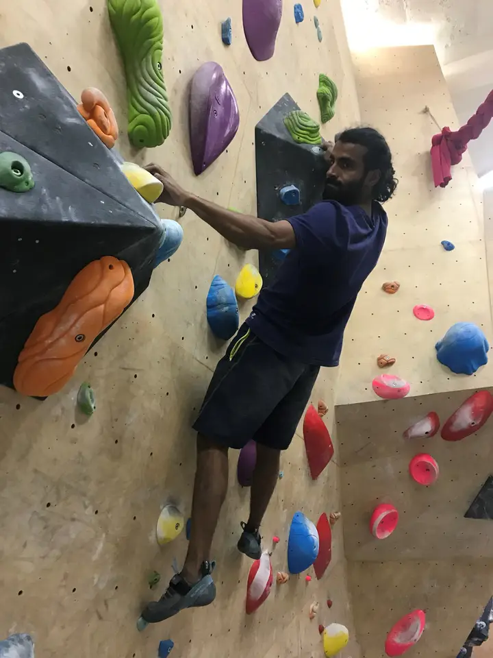 Dhillan edging with his left foot on a little hold.